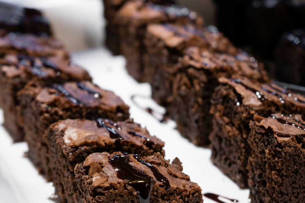 Row of brownies on a white plate with a blurred background